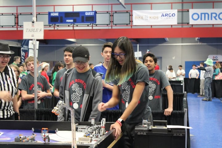 young people at a robotics tournament