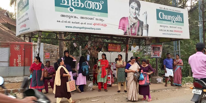 passengers waiting at a covered bus stop in India