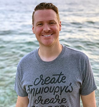 David Neff standing by the water and wearing a Create T-shirt