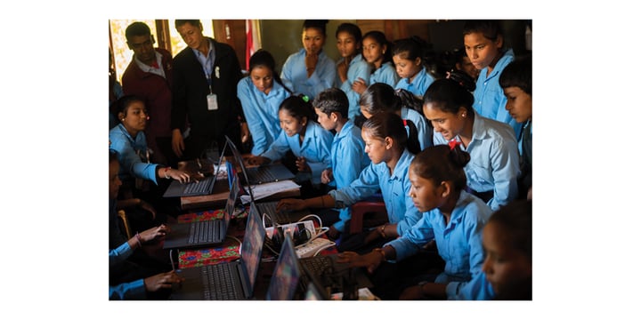 several students using laptops; others observing