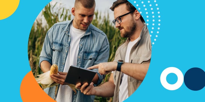 two men in a cornfield look at a tablet connected to a Mobile Beacon hotspot