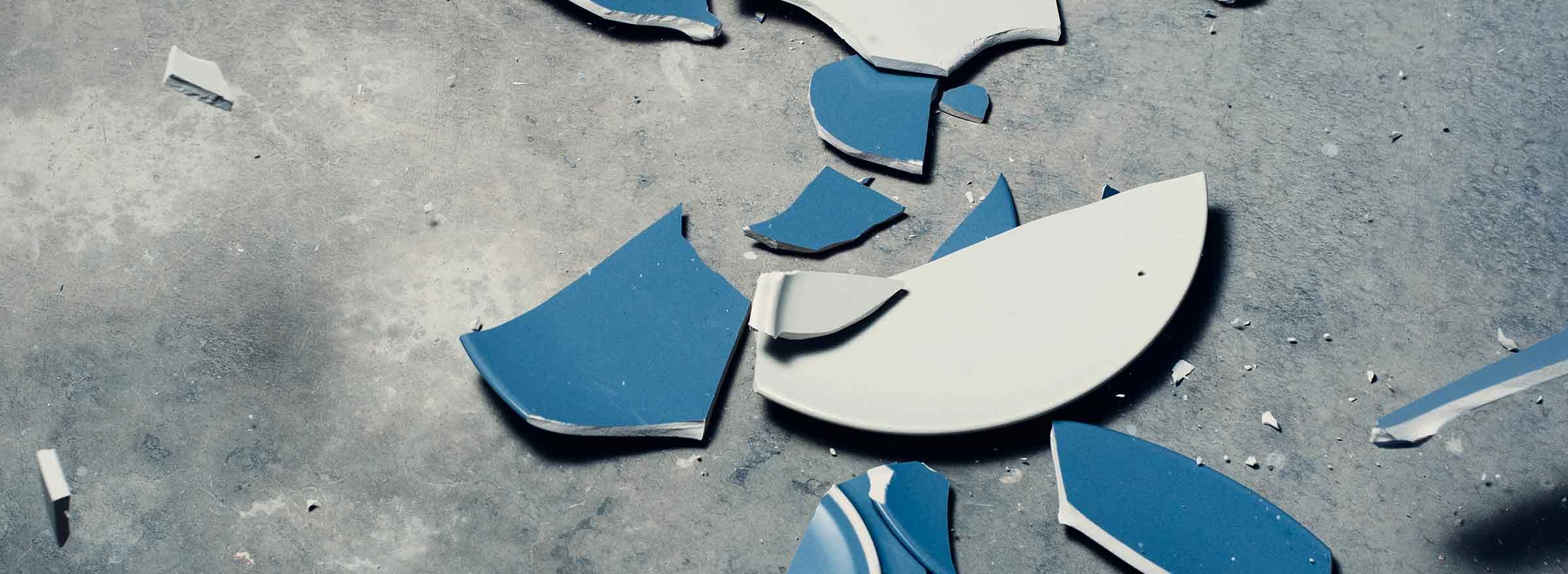 broken dishes on the floor, symbolizing how one nonprofit uses dell computers to fight domestic abuse