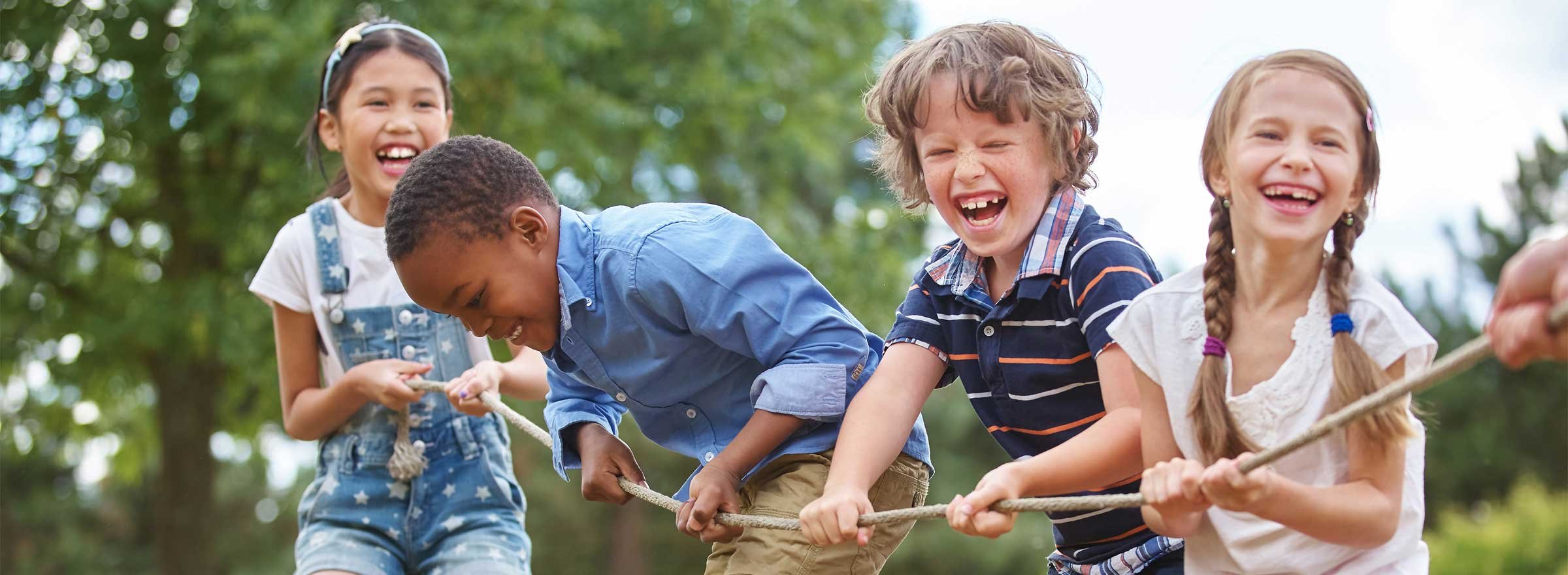 four children on one end of a game of tug of war