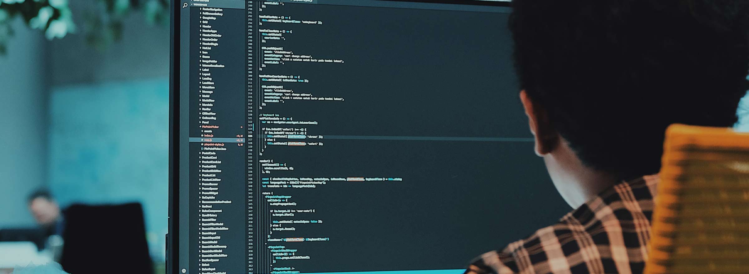 man looking at a screen of computer code