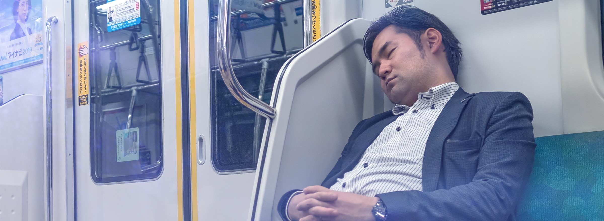 man sleeping on public transit