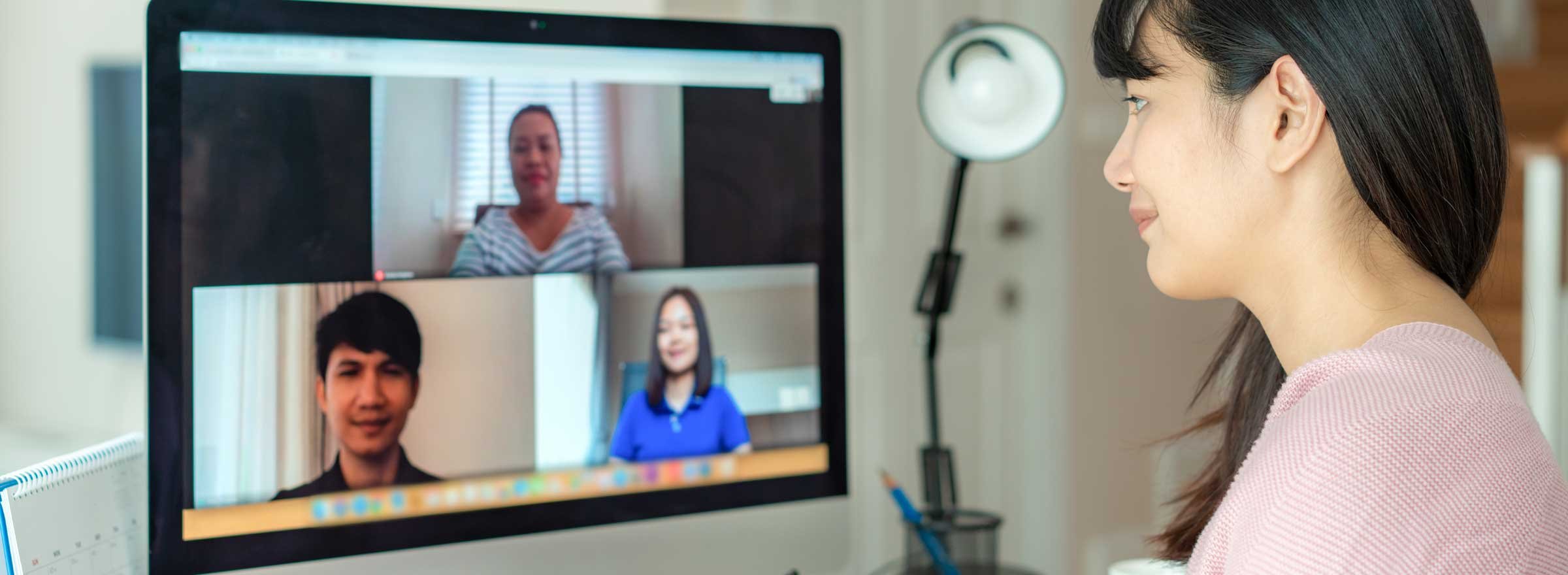 woman in video conference with three other people