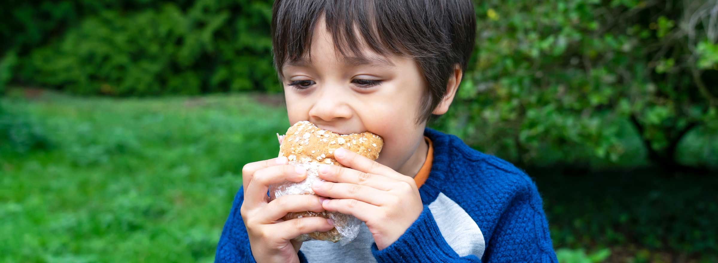 child eating a sandwich