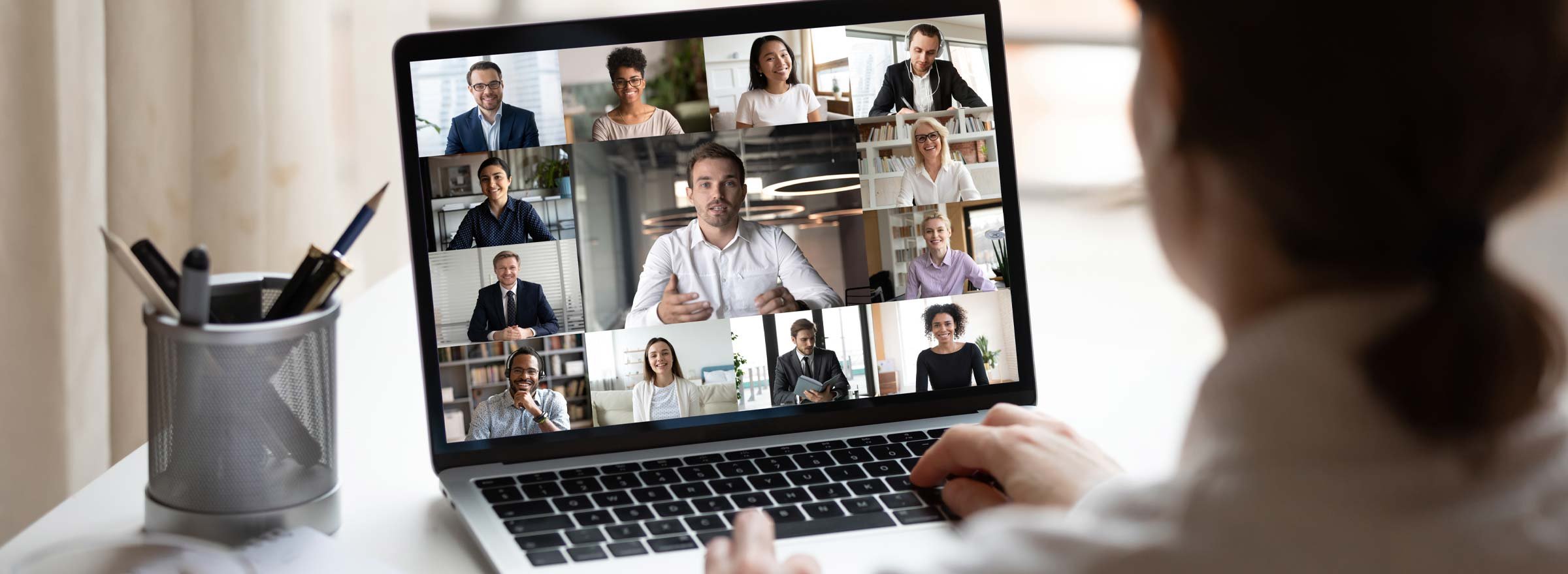 woman having an online video conference with 12 other people