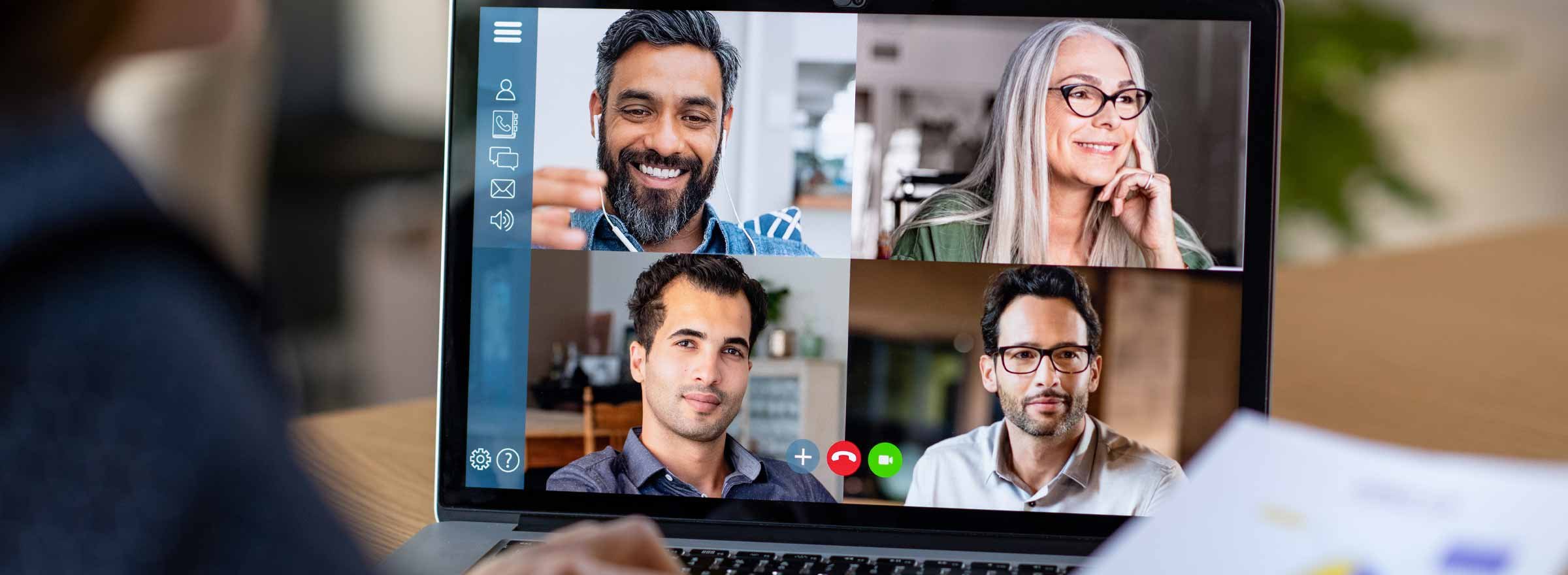 laptop showing four people in video conference