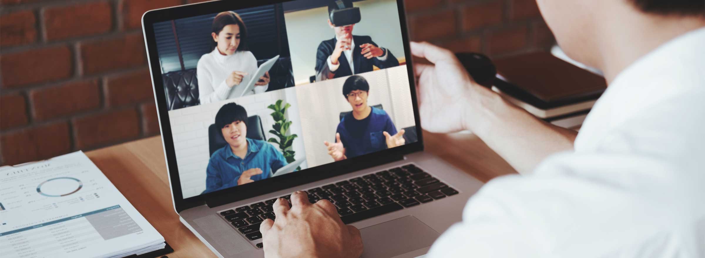 man having a video conference with four people