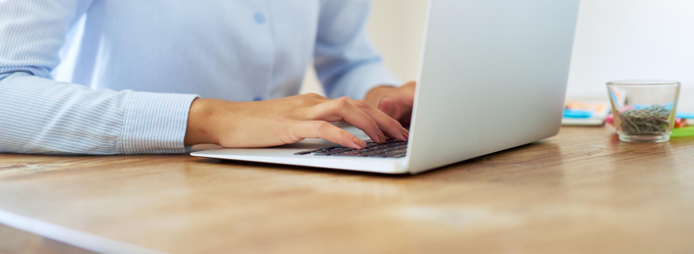 woman's hands on a laptop keyboard