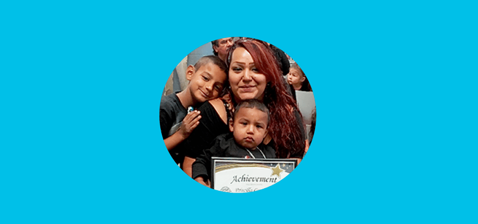 photo of a woman with her children holding her certificate of achievement from Smooth Transitions