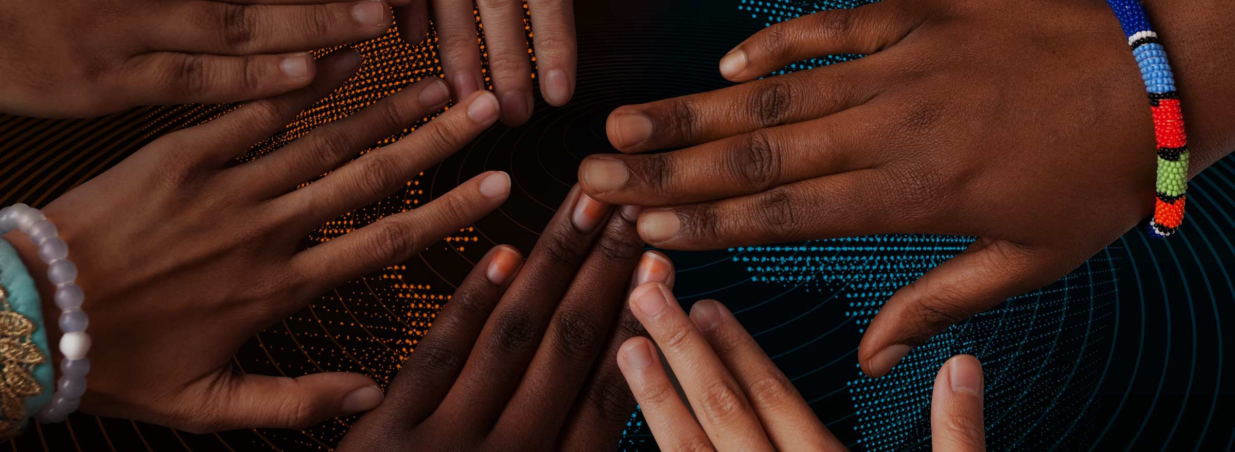hands of people from many races with fingers outstretched toward each other