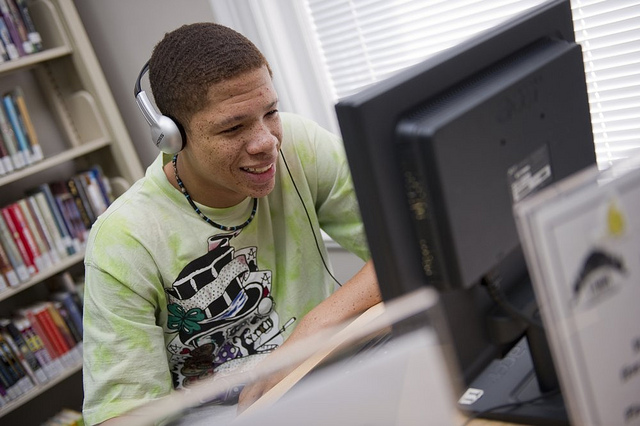 Teen on a computer at the library