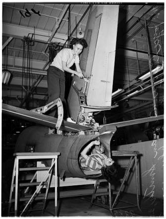 Two women working on manufacturing a plane at Lockheed factory in 1950s